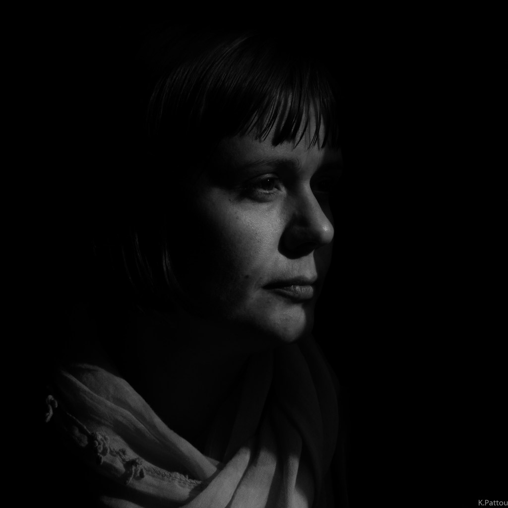 Staring out the window, a low-key portrait.